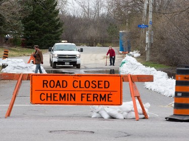 A road closed near Churchill Ave North where residents have been asked to avoid using toilets and showers due to overwhelmed sewers in the area as the Ottawa River continues to rise with no let up for the next few days.
