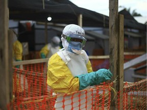 In this Tuesday April, 16, 2019 file photo, an Ebola health worker is seen at a treatment center in Beni, Eastern Congo. Internal documents by The Associated Press show the World Health Organization spent nearly $192 million on travel last year, with staffers sometimes breaking the rules by flying in business class, booking expensive last-minute tickets and traveling without the required approvals.