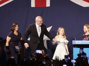 Australian Prime Minister Scott Morrison, second left, arrives on stage to speak to party supporters flanked by his wife, Jenny, left, and daughters Lily, and Abbey, right, after his opponent conceded in the federal election in Sydney, Australia, Sunday, May 19, 2019. Australia's ruling conservative coalition, lead by Morrison, won a surprise victory in the country's general election, defying opinion polls that had tipped the center-left opposition party to oust it from power and promising an end to the revolving door of national leaders.