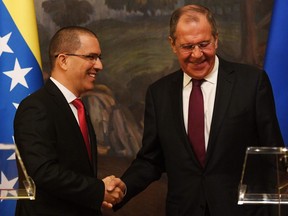 Russian Foreign Minister Sergei Lavrov (R) and Venezuela's Foreign Minister Jorge Arreaza shake hands as they give a press conference in Moscow on May 5, 2019.