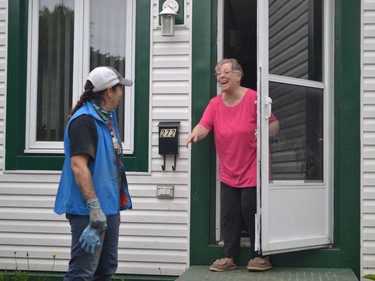 Volunteers stepped up Saturday to de-sandbag homes in the Lac-Beauchamp district of Gatineau. Marcelle Bousquet (pink shirt) only returned to her home on Rue Saint-Sauveur on Thursday.