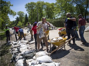 Volunteers, city staff and area residents were out working to clean up the sandbags in Constance Bay Saturday June 8, 2019.   Ashley Fraser/Postmedia