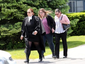 Kirsten Pemberton, centre, holds hands with her mother, Alicia Pemberton, with lawyer Dawn Quelch out of the Lennox and Addington County Court House at the end of the final day of Pemberton's sentencing in Napanee on Wednesday, June 12, 2019.