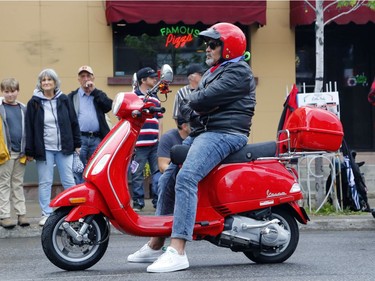A scooter owner takes part in the Italian car parade as part of the Italian Festival on Saturday.