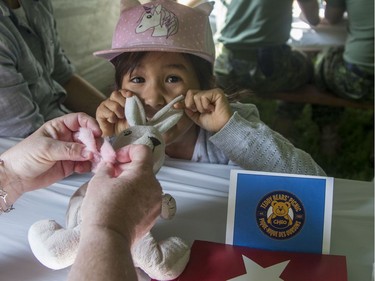 Emilie Ngo Horton, 6, waits excitedly as a medic works on Rebecca, a bunny with an upset stomach and a cold, at the annual CHEO Teddy Bear picnic on Saturday.