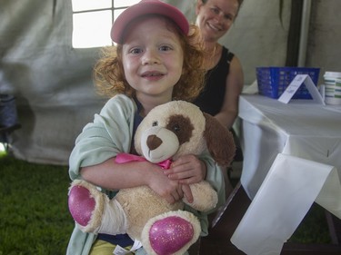 Morgan Kimarbour, 3, is all smiles (sort of) after Ella Bear, who'd stepped on some Lego while running, was patched up at the CHEO Teddy Bear picnic.