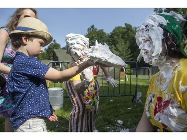 Caelan Hodson, 5, gets some advice on pie-throwing before letting one fly at the annual CHEO Teddy Bear picnic at Rideau Hall on Saturday.