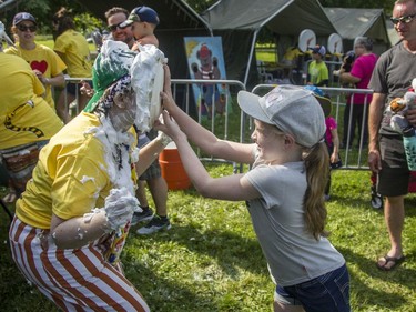 Clara Hearty, 10, goes full-bore at a clown with a pie at the annual CHEO Teddy Bear picnic at Rideau Hall.