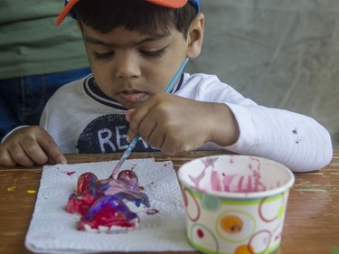 Three-and-a-half-year-old Simba paints a ceramic bear at the annual CHEO Teddy Bear picnic at Rideau Hall on Saturday.