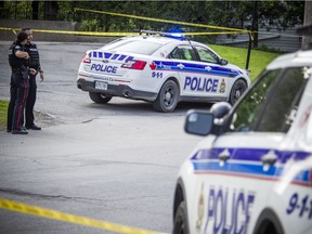 Ottawa police are shown on site of a shooting in the area of High Street and Carling Ave. Saturday, June 22, 2019, that sent two men to the hospital.