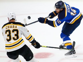 A shot by Blues centre Brayden Schenn (10) bounces off Bruins captain Zdeno Chara after striking him in the face during Game 4 at St. Louis on Monday night.