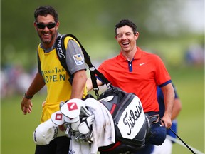 Rory McIlroy, right, celebrates with Paul Tesori, the caddy for Webb Simpson, after winning the RBC Canadian Open at Hamilton Golf and Country Club on Sunday.