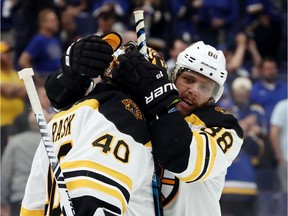 Tuukka Rask (40) and David Pastrnak of the Bruins celebrate their team's 5-1 win over the Blues in Game 6 on Sunday night in St. Louis.