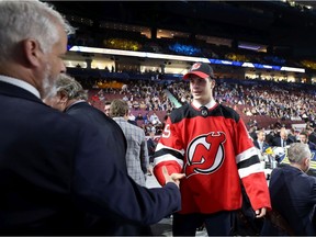 Nikita Okhotyuk receives congratulations after he is selected 61st overall by the New Jersey Devils during the NHL Draft in Vancouver on Saturday.
