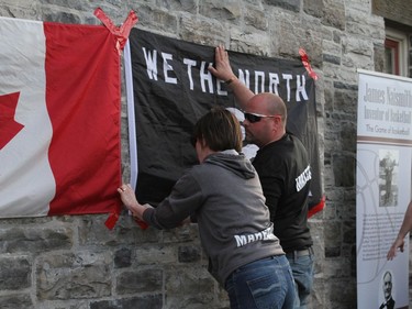Moira and Shawn Maheral of the Naismith Basketball Association put up a "We the North" flag to show support for the Raptors ahead of Sunday's matchup with the Warriors in Toronto