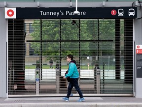 Pedestrians walk past the Tunney's Pasture LRT station which remains closed and will continue to do so for the next while as the system continues to be plagued with failures. Wayne Cuddington / Postmedia