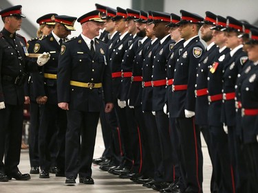 Interim Police Chief Steven Bell inspects the recruits as 88 Ottawa Police Service recruits received their police badges as part of the graduating ceremony held at the EY Centre.