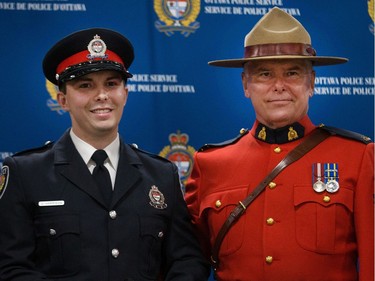 Graham Harrison (left) is presented his badge by his father RCMP S/Sgt Wayne Harrison (right) (retired).