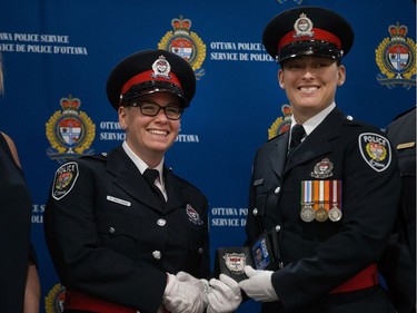 Amanda Williams (left) is presented her badge by mentor Cst Amanda Budzinski.