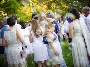 Guests enjoy the warm summer evening after the skies cleared for the reception.