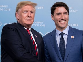 (FILES) In this file photo taken on June 8, 2018, US President Donald Trump and Canadian Prime Minister Justin Trudeau hold a meeting on the sidelines of the G7 Summit in La Malbaie, Quebec, Canada.