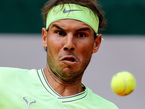 Spain's Rafael Nadal eyes the ball as he returns it to Japan's Kei Nishikori during their men's singles quarterfinal match in the French Open on Tuesday.