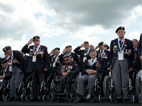 Files: Canadian veterans stand for the National Anthem during the international ceremony on Juno Beach in Courseulles-sur-Mer, Normandy, northwestern France, on June 6, 2019, as part of D-Day commemorations.