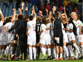 Canadian players celebrate at the end of Monday's contest against Cameroon at the Mosson Stadium in Montpellier.