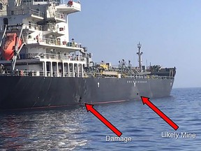 TOPSHOT - This handout powerpoint slide provided by U.S. Central Command damage shows an explosion (L) and a likely limpet mine can be seen on the hull of the civilian vessel M/V Kokuka Courageous in the Gulf of Oman, June 13, 2019, as the guided-missile destroyer USS Bainbridge (DDG 96)(not pictured) approaches the damaged ship.