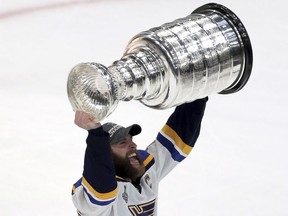 The St. Louis Blues' Alex Pietrangelo carries the Stanley Cup after the Blues defeated the Boston Bruins in Game 7 of the NHL Stanley Cup final on Wednesday, June 12, 2019, in Boston.