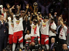 Toronto Raptors guard Kyle Lowry lifts up the Larry O'Brien Championship Trophy after a Game 6 win over the Golden State Warriors at Oracle Arena on Thursday, June 13, 2019.