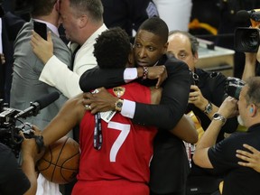 Toronto Raptors president Masai Ujiri (right) hugs guard Kyle Lowry (7) after defeating the Golden State Warriors in game six of the 2019 NBA Finals to win the NBA Championship at Oracle Arena.