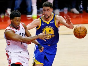 Toronto Raptors guard Kyle Lowry (7) passes in front of Golden State Warriors guard Klay Thompson (11) during the fourth quarter in game five of the 2019 NBA Finals at Scotiabank Arena in Toronto.