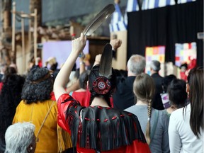A woman holds an eagle feather during the closing ceremony of the National Inquiry into Missing and Murdered Indigenous Women and Girls in Gatineau, Quebec, Canada, June 3, 2019.
