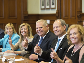 Ontario Premier Doug Ford sits with members of his cabinet after a cabinet shuffle at Queens Park on June 20, 2019.