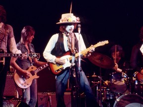 Bob Dylan in whiteface, playing on the Rolling Thunder Revue tour.