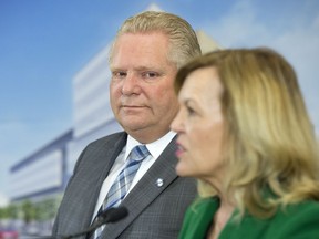 Ontario Premier Doug Ford watches as Health Minister Christine Elliott speaks at an event in Toronto earlier this year.