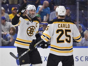 Bruins defenceman Zdeno Chara, left, celebrates with Brandon Carlo after scoring a goal in Game 6 on Sunday night.
