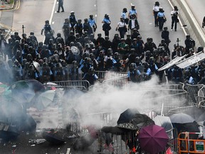 Police clash with protesters during a rally against a controversial extradition law proposal outside the government headquarters in Hong Kong on June 12, 2019.