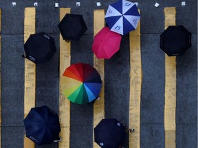 People holding umbrellas.
