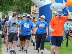 Wearing matching blue T-shirts, Abel Macias, left, and wife Erin participate in the 26th annual London Brain Tumour Walk. The couple, who met through an online support group for brain tumour survivors, led the walk around Victoria Park in London on Sunday, June 9, 2019. DALE CARRUTHERS / THE LONDON FREE PRESS