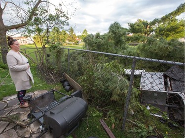 Dana Miller surveys damage in her backyard as a reported tornado touched down in the Orléans suburb of Ottawa on Sunday evening. Wayne Cuddington / Postmedia