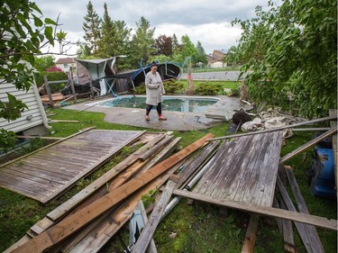 Dana Miller surveys damage in her backyard as a reported tornado touched down in the Orléans suburb of Ottawa on Sunday evening. Wayne Cuddington / Postmedia