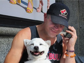 Dave M., a homeless man whose American Eskimo dog Cutiepie was stolen last month reunited with his dog on Granville St in Vancouver, BC., June 16, 2019.