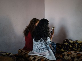 A Yazidi girl, 14, speaks with her father in Sinjar, Iraq, via video call on WhatsApp on May 29, 2019, near Hasakah, Syria. M