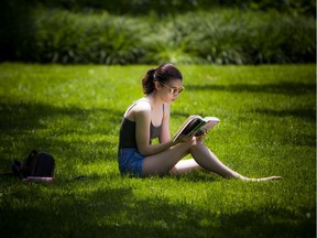 Katie Montour enjoyed the lovely weather and her book in Confederation Park while the Ottawa Jazz Festival took place Saturday June 22, 2019.