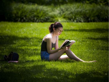 Katie Montour enjoyed the lovely weather and her book in Confederation Park while the Ottawa Jazz Festival took place Saturday June 22, 2019.   Ashley Fraser/Postmedia