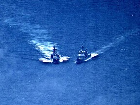 A surveillance photo shows the Russian naval destroyer Udaloy making what the U.S. Navy describes as an unsafe maneuver against the Ticonderoga-class guided-missile cruiser USS Chancellorsville in the Philippine Sea June 7, 2019.