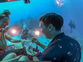 Justin McIntaggart proposes to Kate Hartberg in a scUber submersible at Australia's Great Barrier Reef. [Tourism and Events Queensland]