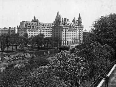 Chateau Laurier Hotel shown in photograph taken from across the Rideau Canal at the back of the Parliament Buildings shortly after hotel expansion in 1929-30. Note railway line running along east side of canal beside and behind the hotel.